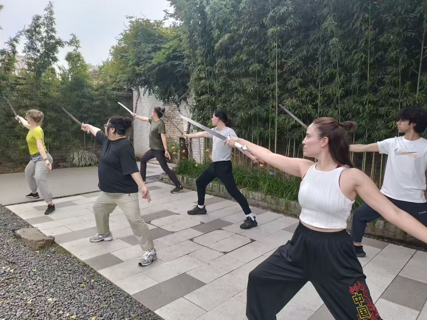 Students practicing Chinese straight sword (Jian) outdoors at SJF Kung Fu School. Students practicing Chinese straight sword (Jian) outdoors at SJF Kung Fu School.