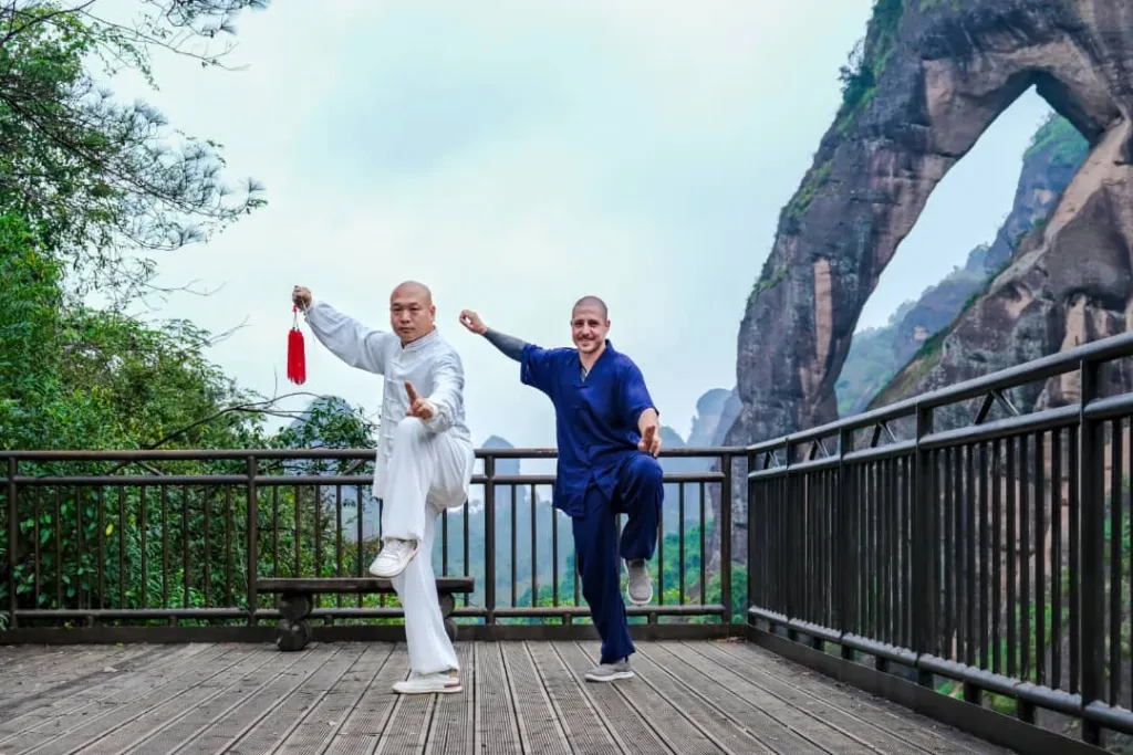 student practising tai chi sword with master shen jiangfei