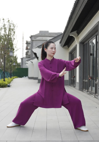 woman practising tai chi in purple tai chi uniform
